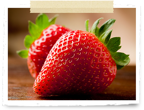 Two strawberries on a wooden plate